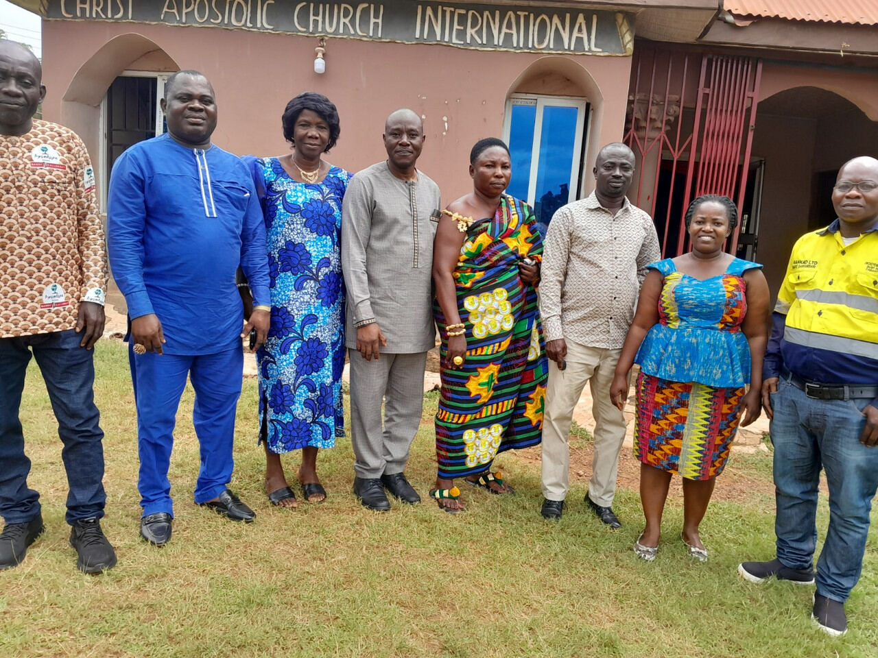 Team members standing with community participants