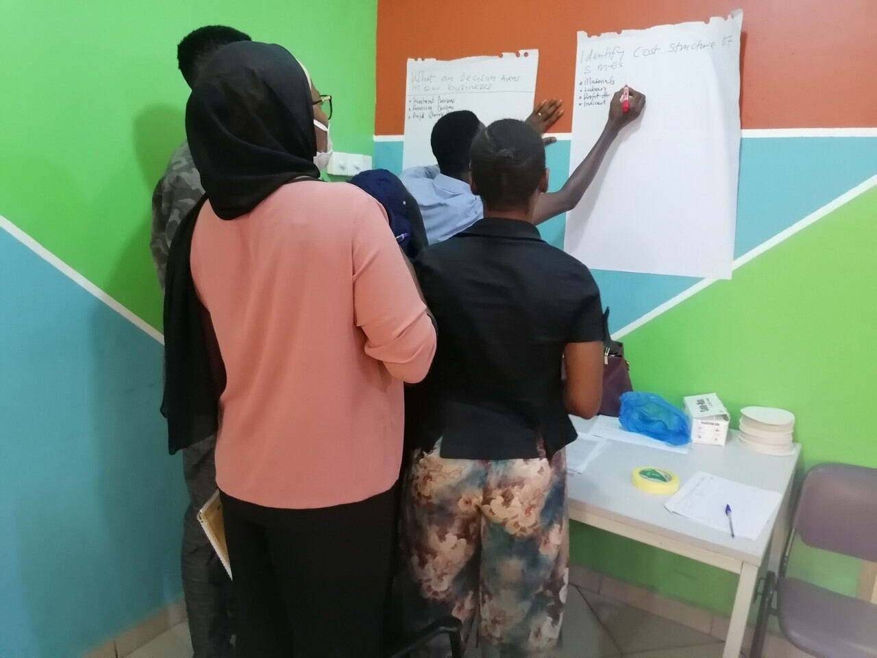 Workshop group working through content on a whiteboard